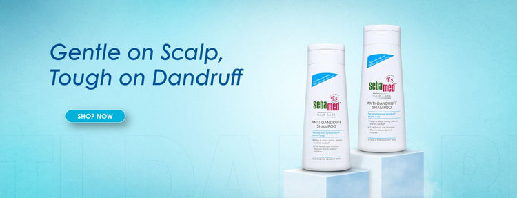 Two bottles of anti dandruff shampoo products on a blue background with text 'Gentle on Scalp, Tough on Dandruff' and 'Shop Now' button.